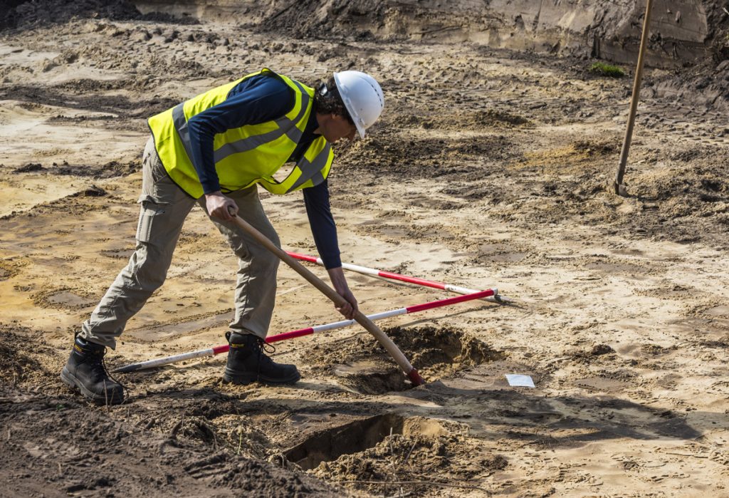 IMAGE: man in hard hat artefact sweeping on Worimi land