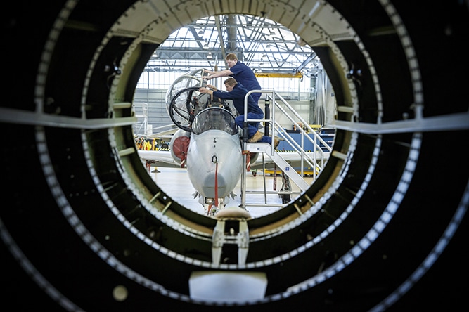 BAE Systems Aircrew Technicians beside Hawk Aircraft